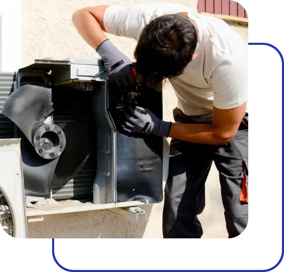 A man working on an air conditioner unit.